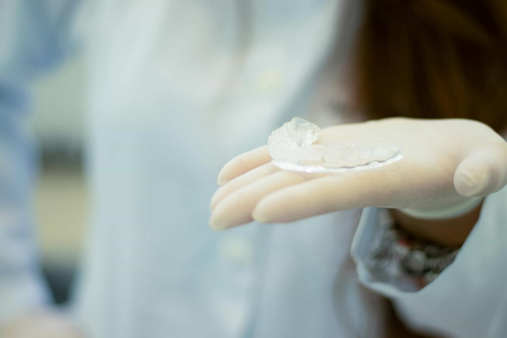 orthodontist showing retainer
